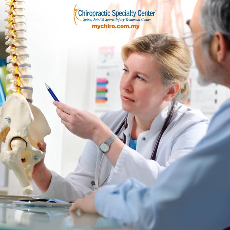 Female Chiropractor consulting male patient in KL