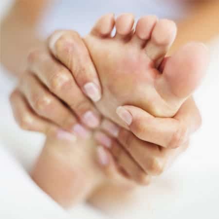 lady holding foot in pain