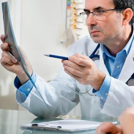 Chiropractor assessing MRI film