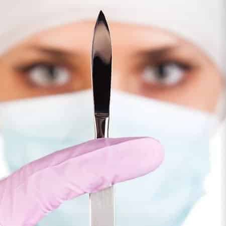 a surgeon with scalpel in hand