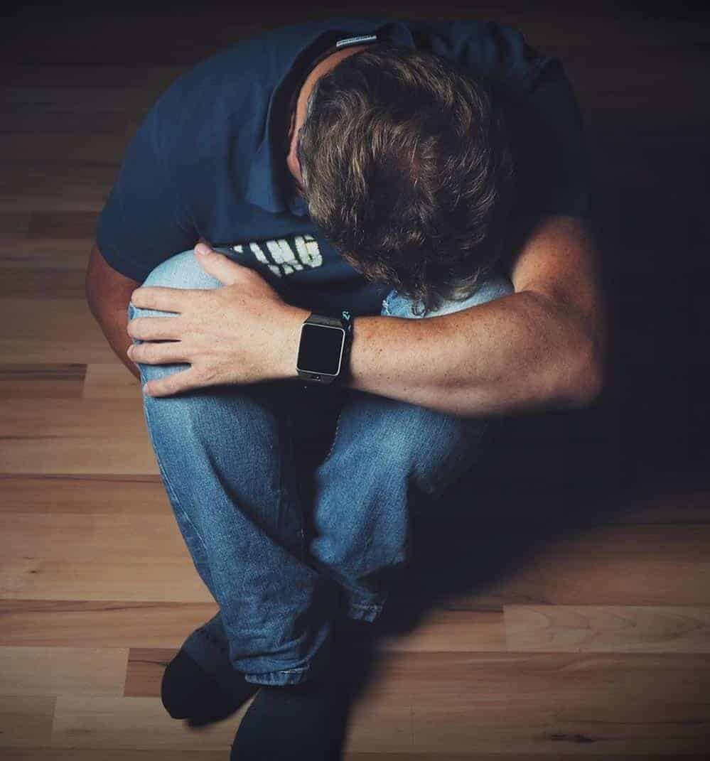 man hunched over due to nerve pain