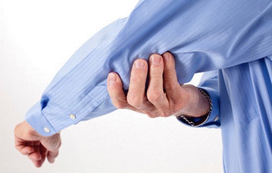man holding elbow in pain