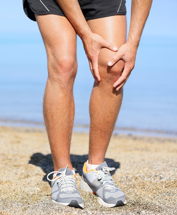 knee pain, man holding knee in pain