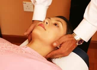 female patient with make chiropractor treating the spine
