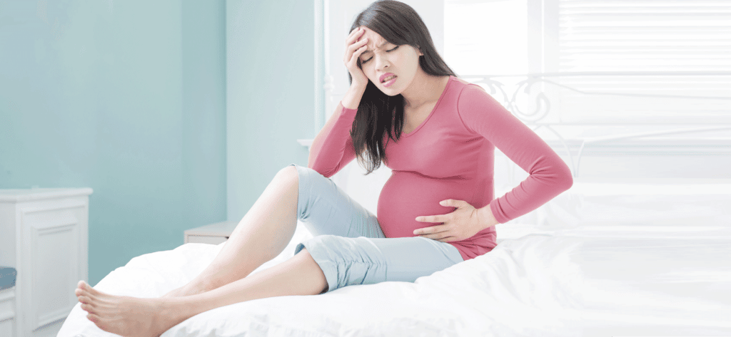 Women with pelvic pain holding tummy